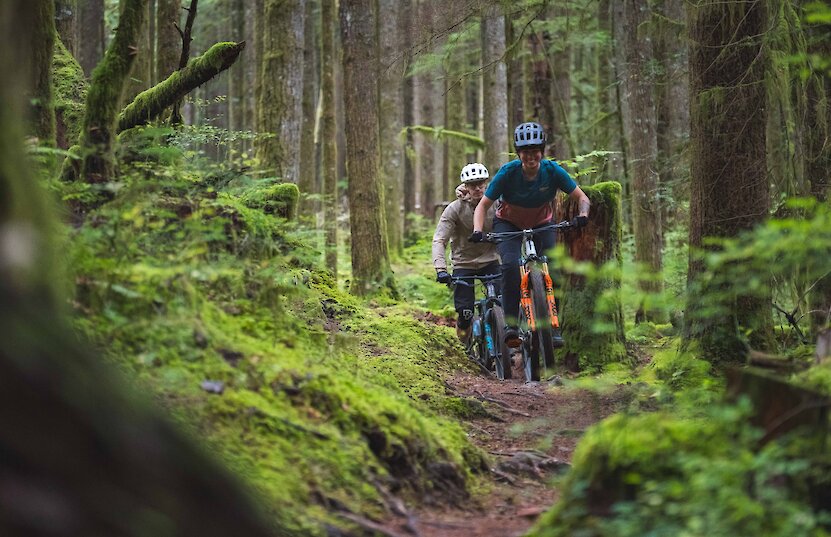 Couple mountain biking in the forest