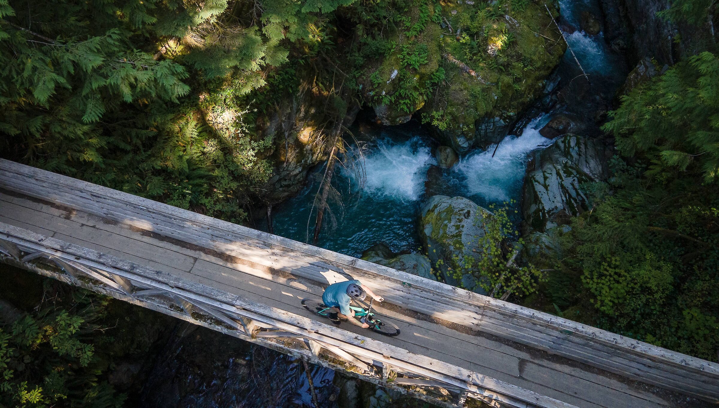 Mountain biker riding across bridge